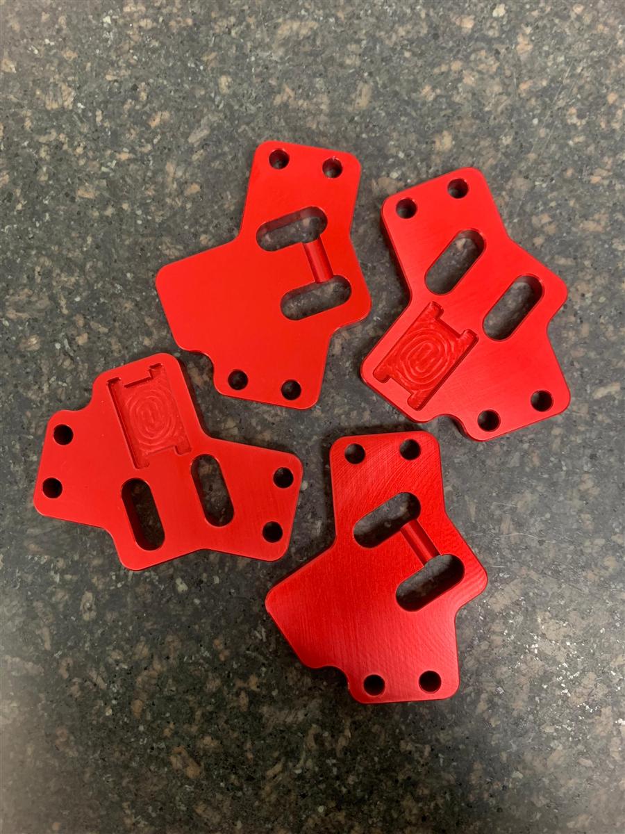 CNC-milled anodised red bracket components